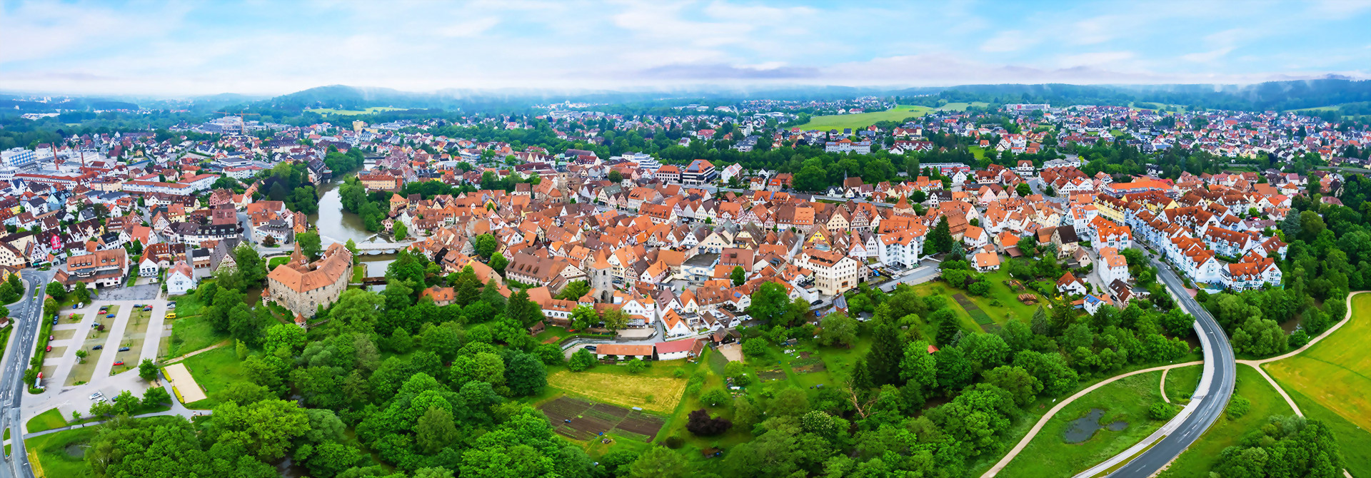 Luftaufnahme von Lauf an der Pegnitz, umgeben von grünen Feldern und sanften Hügeln.